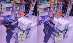 Alarmları söktü, alkol şişelerini pantolonuna sakladı: Hırsızlık anı saniye saniye kamerada!